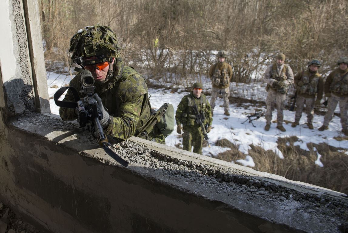 A Canadian soldier from India Company clears the room before entering through the window during Joint Urban Operation training with the Latvian Army National Guard 32nd Infantry Battalion in Mārciena, Latvia, as part of Operation REASSURANCE eFP on March 17, 2018. Images by Cpl Jean-Roch Chabot, eFP BG LATVIA PUBLIC AFFAIRS RP15-2018-0074-075