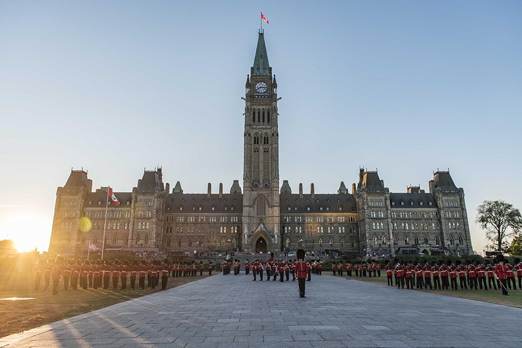 Members of the Ceremonial Guard prepare to march off as the sun sets during the annual Fortissimo event on Parliament Hill in Ottawa, Ontario on July 19, 2018. Photo: Ordinary Seaman Camden Scott, Army Public Affairs. ©2018 DND/MDN Canada. 