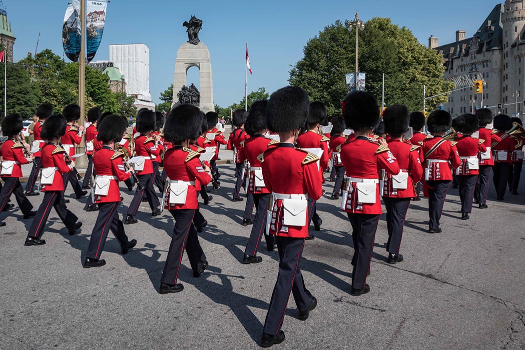 The Ceremonial Guard Band parades up Elgin Street in Ottawa, Ontario, passing in front of the National War Memorial and the Tomb of the Unknown Soldier on the way to Parliament Hill during the Changing of the Guard ceremony on July 9, 2019. Photo: Able Seaman Camden Scott, Army Public Affairs. ©2019 DND/MDN Canada.