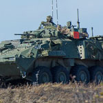 Members of 2nd Battalion, Princess Patricia's Canadian Light Infantry advance on an objective with the support of a Light Armoured Vehicle during a Platoon level group attack with live firing during Exercise KAPYONG MACE at CFB Shilo, Manitoba on September 26, 2015. Photo: MCpl Louis Brunet, Canadian Army Public Affairs 
