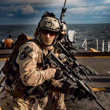 A member of the Maritime Tactical Operations Group holding a C8A3 carbine rifle during a range proficiency shoot aboard HMCS CHARLOTTETOWN.