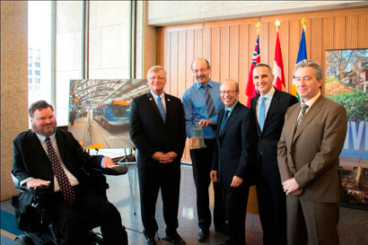 From left to right:<br>
       	    Participating in an event recognizing the many awards received by Phase&nbsp;1 of the Winnipeg Southwest Rapid Transit project were the Honourable Steven Fletcher, Member of Parliament for Charleswood&mdash;St. James&mdash;Assiniboia; David Krahn, Partner with Dillon Consulting, Kas Zurek P. Eng., President Elect of the Manitoba Chapter of Canadian Public Works Association; Sam Katz, Mayor of Winnipeg; Kevin Chief, Minister responsible for relations with the City of Winnipeg within the Department of Municipal Government; and Dave Wardrop, Director of Winnipeg Transit.