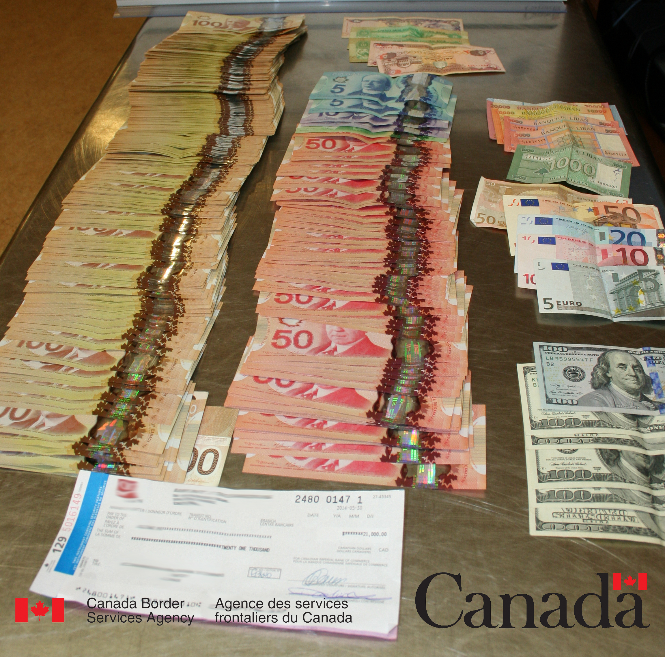 $67,840 in currency seized by CBSA officers at the Edmonton International Airport on June 1.