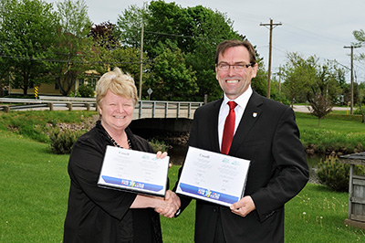 (from Left to Right): The Honourable Gail Shea, Minister of Fisheries and Oceans, and Member of Parliament for Egmont, and Robert Vessey, Prince Edward Island Minister of Transportation and Infrastructure Renewal celebrate the renewed federal Gas Tax Fund agreement.