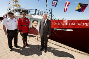 From right to left: Member of Parliament Bryan Hayes, Royal Canadian Mounted Police Superintendent Guy Rook and Canadian Coast Guard Assistant Commissioner - Central Arctic Region, Mario Pelletier with a portrait of the CCGS Constable Carrière namesake.