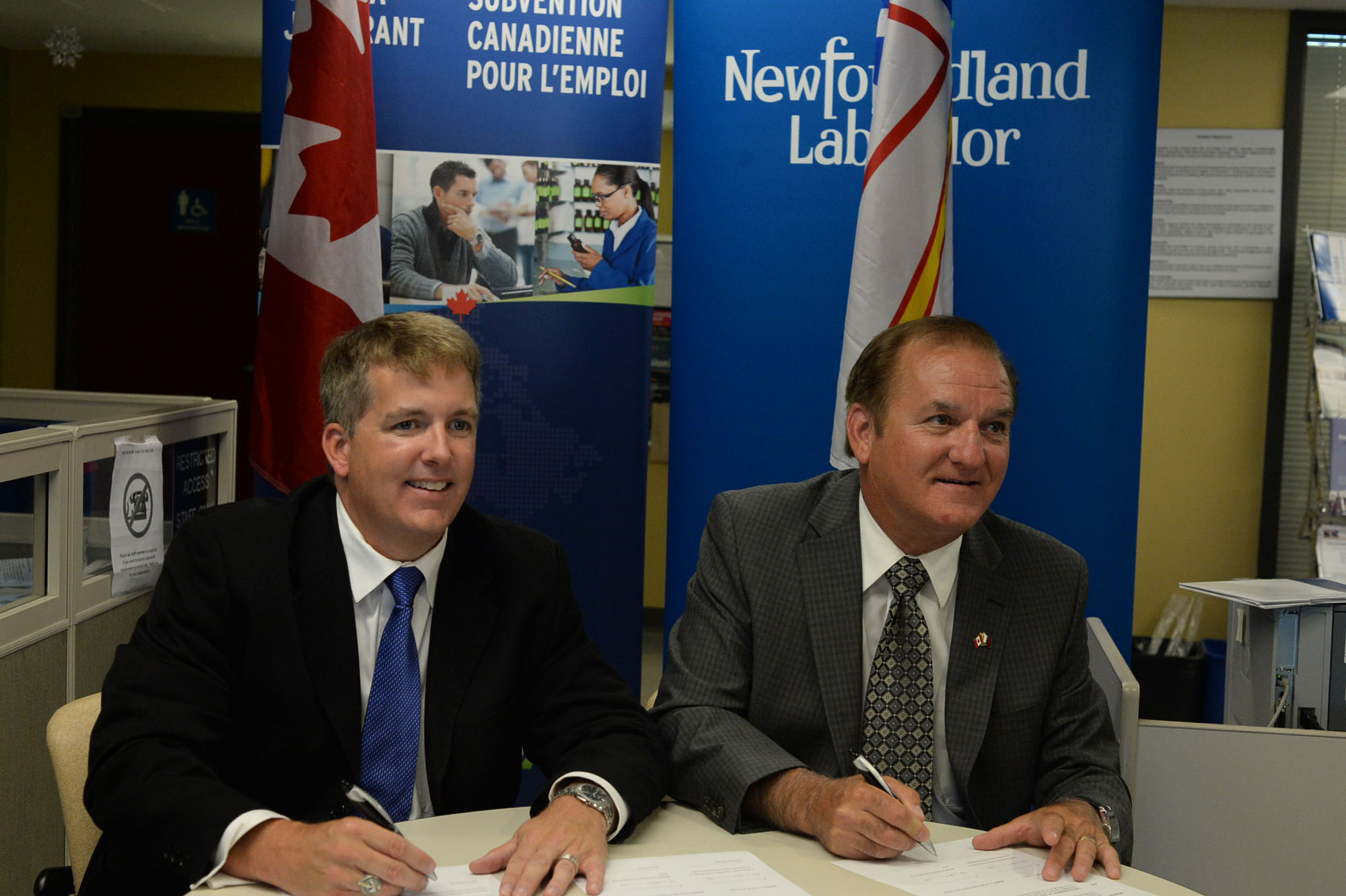 Scott Armstrong, Parliamentary Secretary to the Minister of Employment and Social Development  with the Honourable Kevin O¿Brien, Minister of Advanced Education and Skills, signing agreements that will help meet labour market demands and assist older workers and persons with disabilities connect to available jobs.