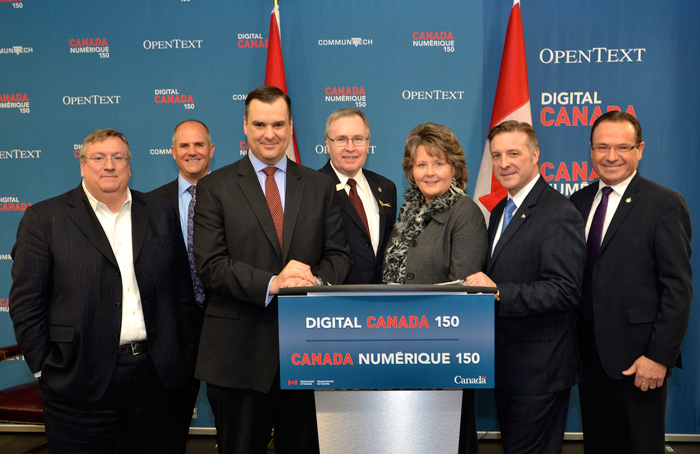 After announcing Digital Canada 150, Industry Minister James Moore is joined at the podium by (from left) OpenText Corp. President and CEO Mark Barrenechea, Communitech President and CEO Iain Klugman, MP for Kitchener Centre Stephen Woodworth, Waterloo Mayor Brenda Halloran, MP for Kitchener¿Waterloo Peter Braid and MP for Kitchener¿Conestoga Harold Albrecht.