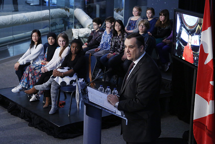 Photo: Local students with Industry Minister James Moore learning about Canada¿s future in space