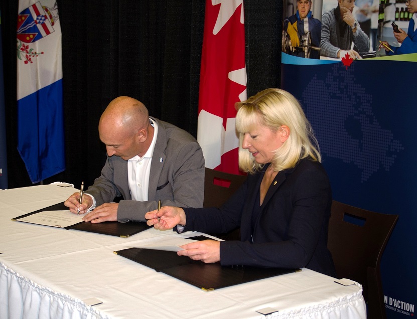 MP Leef and Minister Taylor signing the agreement.