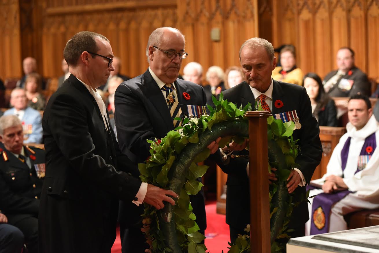 The Honourable Julian Fantino, Minister of Veterans Affairs, joins Senator Joseph Day  and Barry Devolin, Deputy Chair of Committees of the Whole, at a ceremony of remembrance in the Senate Chamber.