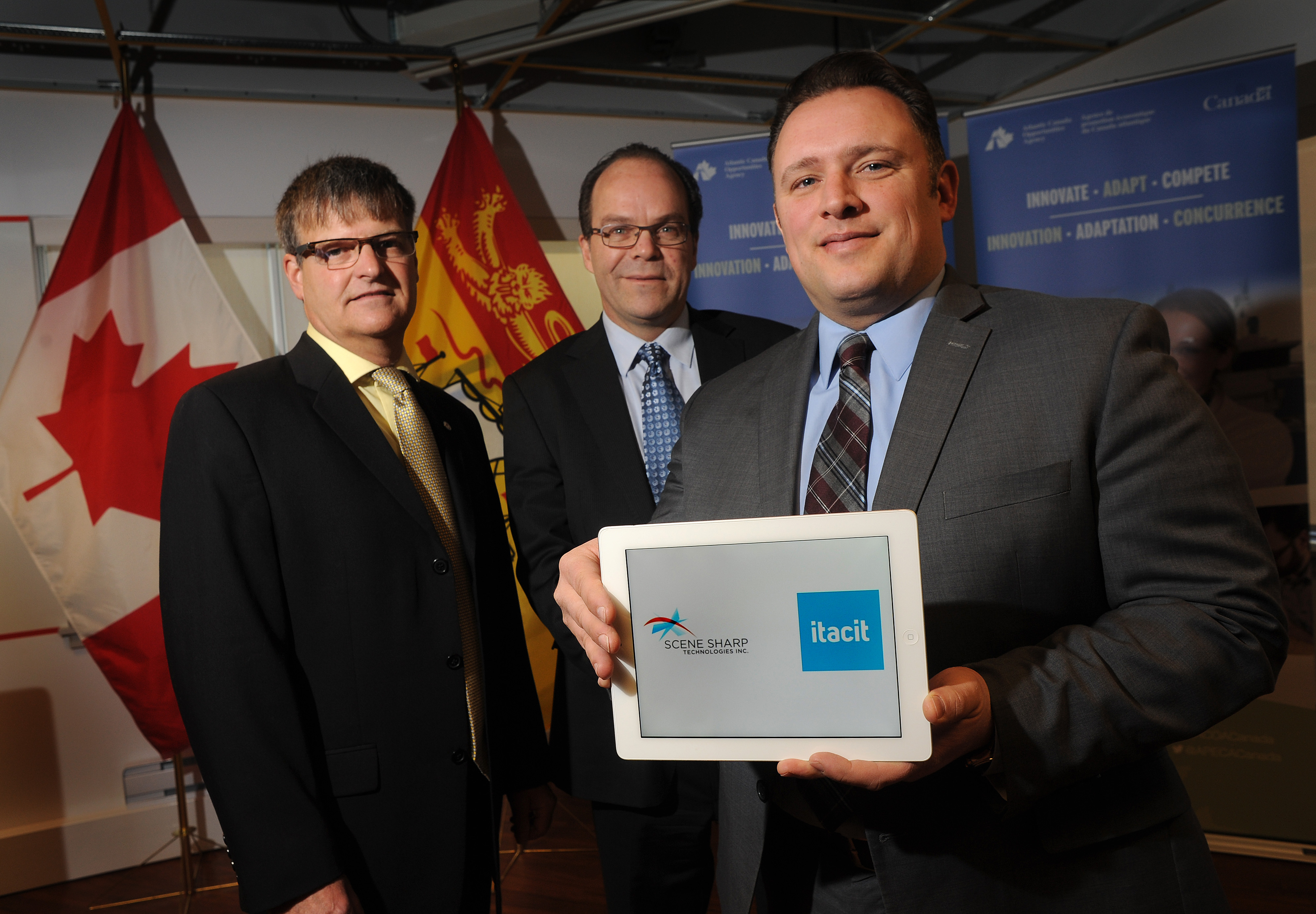 January 21, 2015 ¿ Fredericton, NB ¿ Atlantic Canada Opportunities Agency

The Honourable Rob Moore, Regional Minister for New Brunswick and Minister of State (Atlantic Canada Opportunities Agency), along with iTacit and Scene Sharp Technologies officials, announced $1 million in support to help both companies develop and launch innovative technologies.

The Government of Canada, through ACOA¿s Business Development Program, is providing repayable contributions of $500,000 towards each company¿s project.  iTacit is investing $470,000 in their project and Scene Sharp Technologies is investing $193,120.

Pictured here celebrating the good news are: Ian Lucas, Chief Executive Officer, Scene Sharp Technologies; Norm Couturier, Chief Product Strategist, iTacit and Minister Moore.
