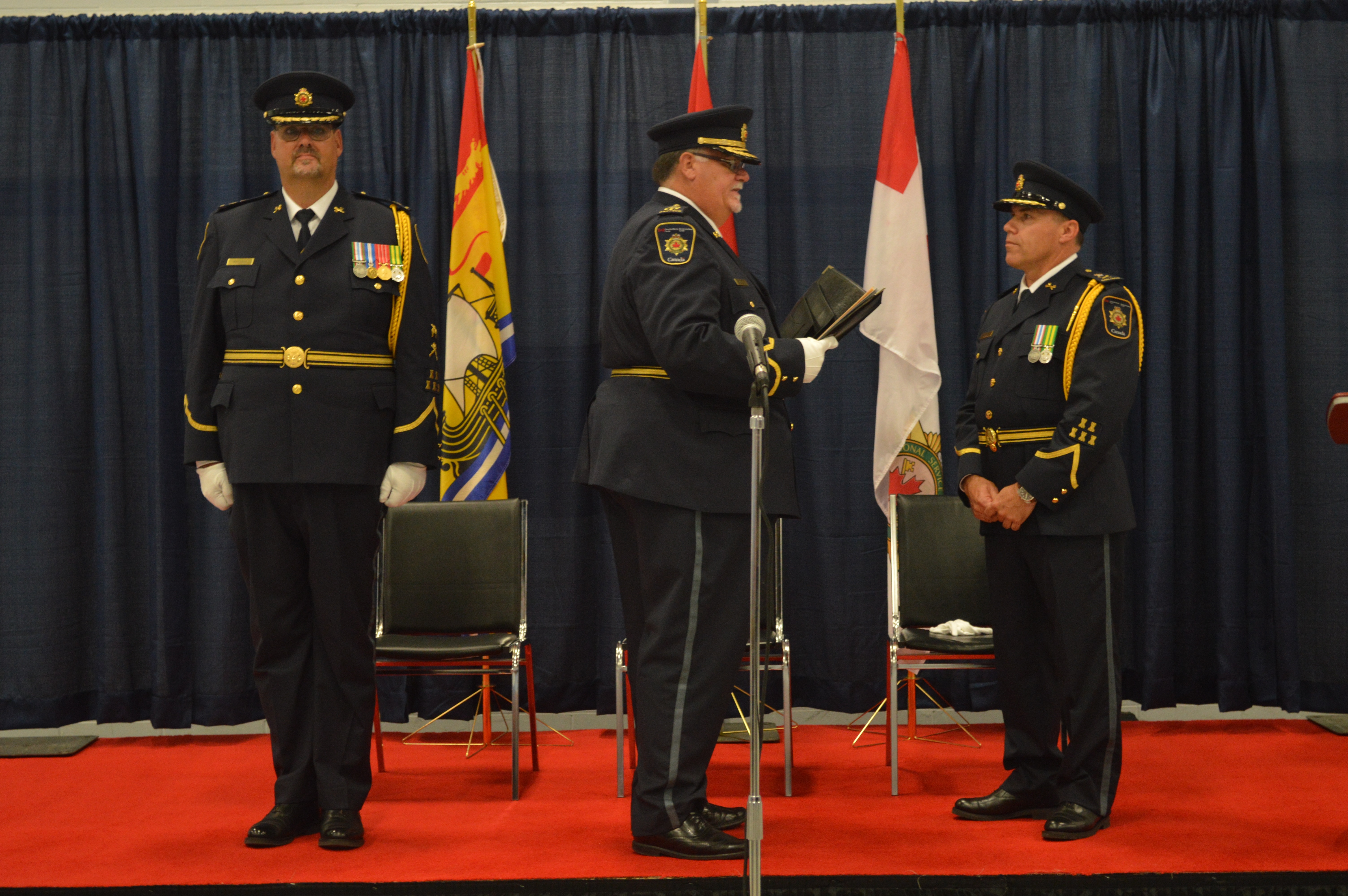 From left to right: Paul Bourque, outgoing Warden, Commissioner Don Head, presiding official, incoming Warden Ed Muise taking Oath. 