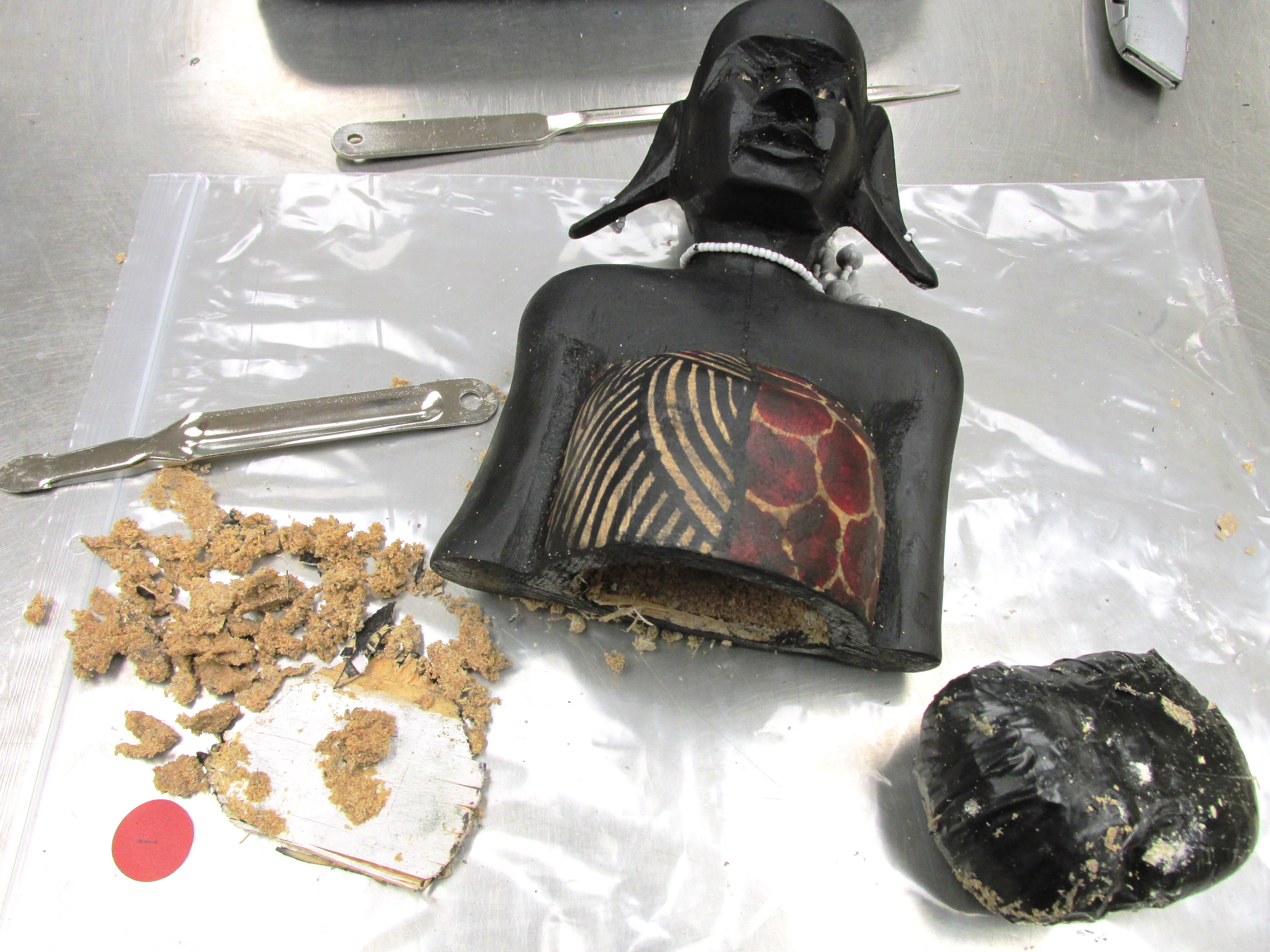 Bags containing suspected heroin were found upon opening the statuettes.