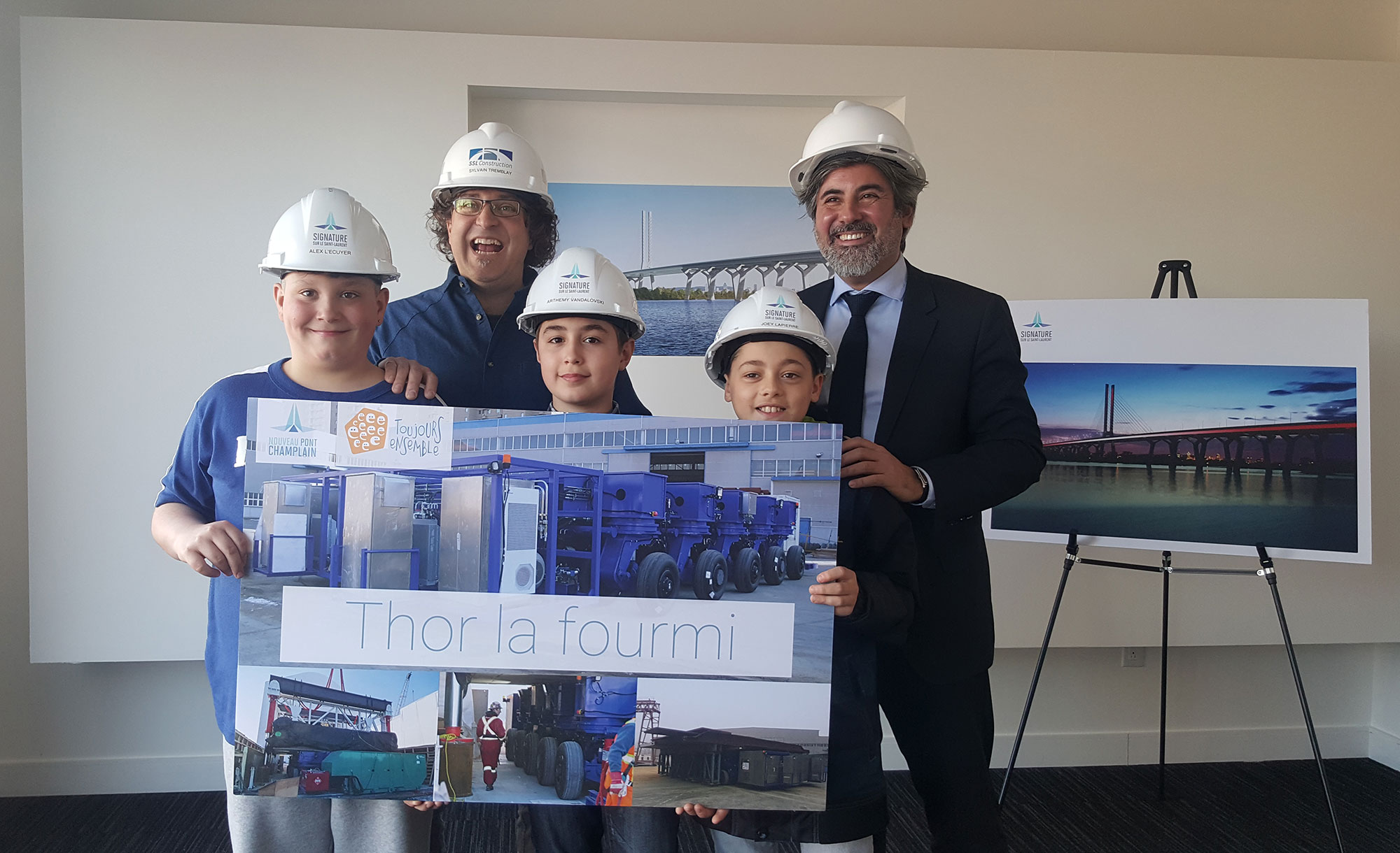 Parliamentary Secretary Pablo Rodriguez joined the young winners of the contest to name the supertransporter being used on the worksite of the new Champlain Bridge.