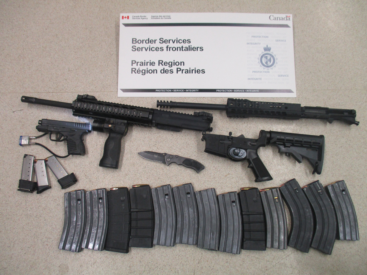 The .45-calibre pistol, 13 overcapacity magazines, prohibited switchblade, and AM-15 semi-automatic assault rifle seized at the North Portal border crossing on May 26.