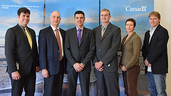 Following the announcement, the Parliamentary Secretary and a few Atlantic Salmon Research Joint Venture partners and project proponents receiving funding posed for a photo. 
From left to right: Neville Crabbe, Atlantic Salmon Federation; Doug Bliss, DFO Science and chair of the ASRJV; Serge Cormier; Dr. Tommi Linnansaari, University of New Brunswick and the Canadian Rivers Institute; Darla Saunders, Atlantic Salmon Conservation Foundation and Michael Duffy, University of New Brunswick.
