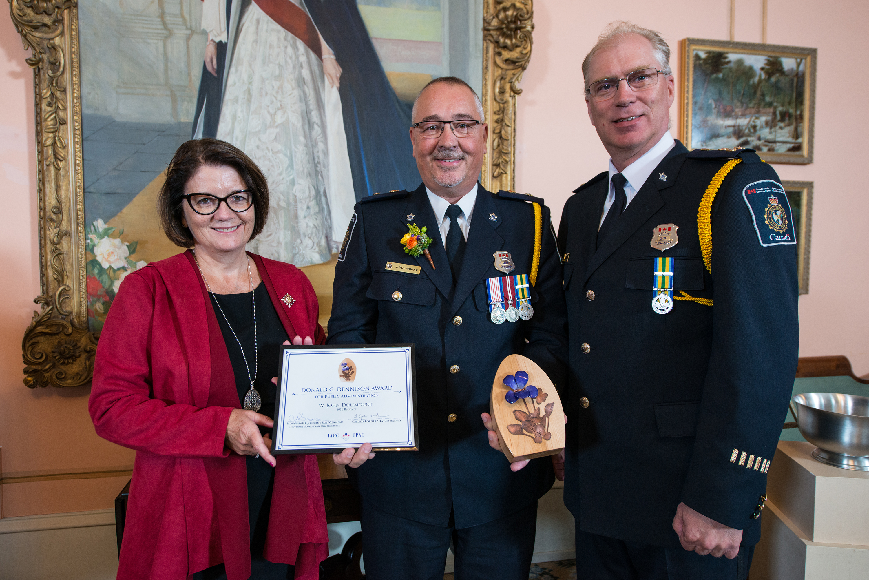Photo of Lieutenant-Governor of New Brunswick, Jocelyne Roy Vienneau, with recipient John Dolimount and Calvin Christiansen, Regional Director General, CBSA, Atlantic Region at the award presentation. Photo credit: Rob Blanchard.
