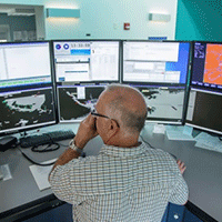 An MCTS officer at their workstation.