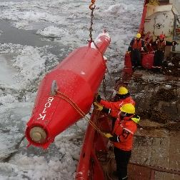 Four-season buoy being lowered into the St. Lawrence river.