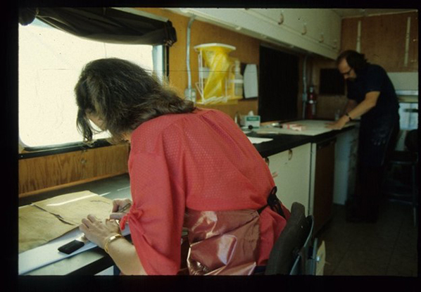 Two conservators working inside the mobile lab.
