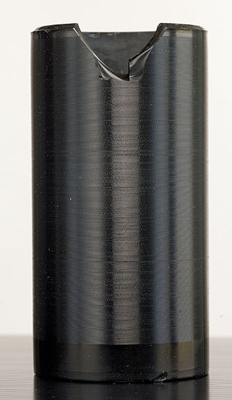 A black music cylinder standing up vertically with a missing piece at the top.