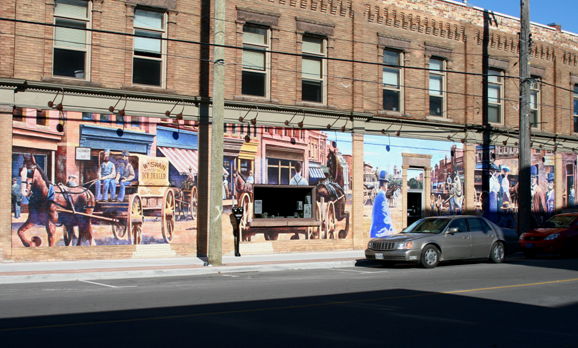 Mural of wagons and horses.