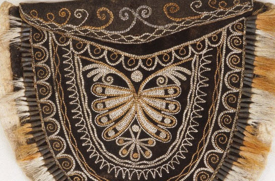 Close-up of black-tanned pouch with butterfly design.