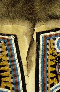 Close-up of tear in article of clothing made of caribou skin.