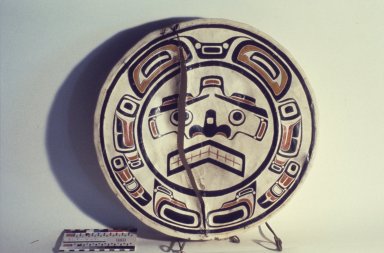 An Indigenous drum has a long split in the drumskin across its diameter, from rim to rim.