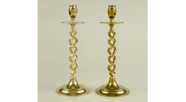 Polished brass candlestick on the left and a tarnished brass candlestick on the right.