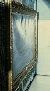 Photograph of a large painting taken from the side to show a central bulge in the canvas and rippling along the top edge.