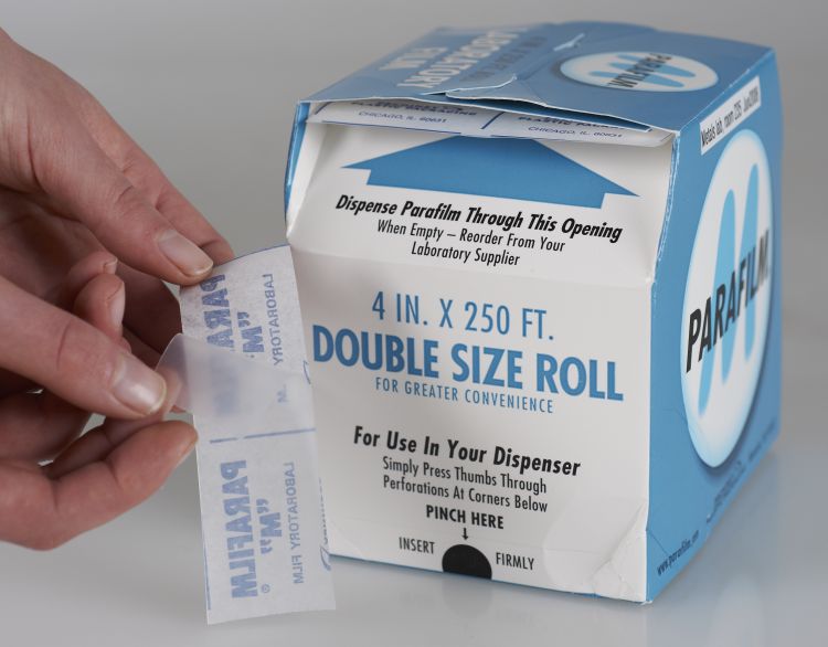 A square box contains a double-size roll of film measuring 4 inches by 250 feet. The roll is fed through an opening at the top of the box.