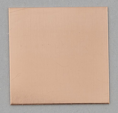 Pure copper coupon before silvering, has a uniform salmon-pink colour