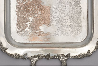Silver-plated copper tray, left shows where abrasive polishing removed silver to uncover areas of copper, right shows where silvering paste applied