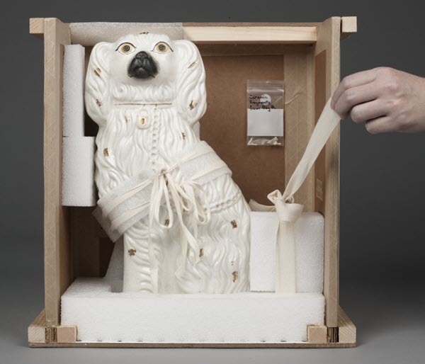 Dog sculpture in its restraint.