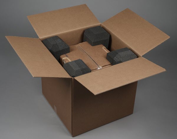 Box containing an inner box protected by eight corner pads.