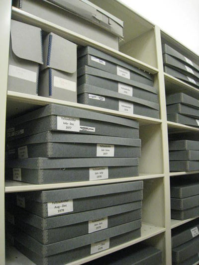 Paperboard boxes used in a storage shelf.
