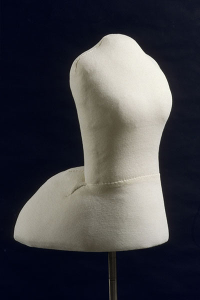 Period mannequin made of polyethylene foam is padded with polyester quilt batting and covered with jersey knit.