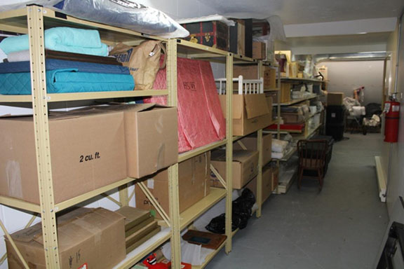 Space containing several objects stored on shelves before RE-ORG