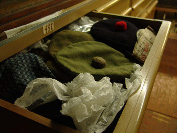 Overcrowded drawers containing hats before RE-ORG