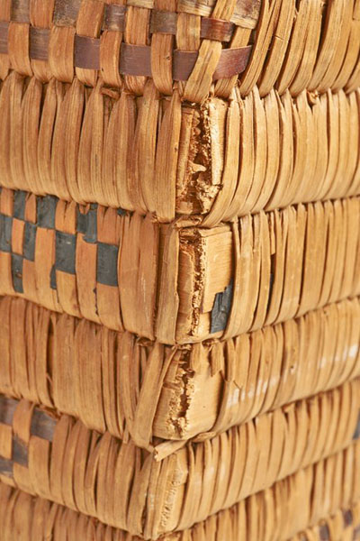 Rectangular basket made up of wood slats.