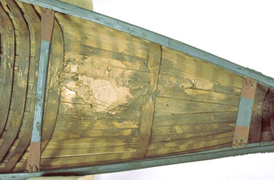 Inside structure of a small model of a birchbark canoe.