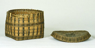A basket and its lid. The rim on the basket is partially damaged. The lid has slumped in the center and its rim has spread out.