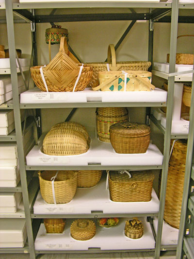 Foam storage mounts, with baskets, within a shelving unit.