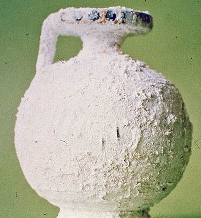 A ceramic vessel covered with salt crystals.