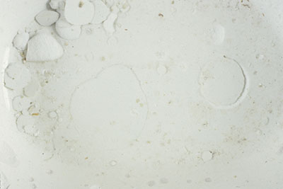 Detail of detached and incipient salt spalls inside a bowl.