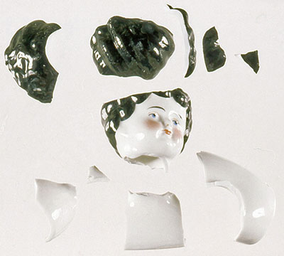The shattered head of a porcelain figurine.
