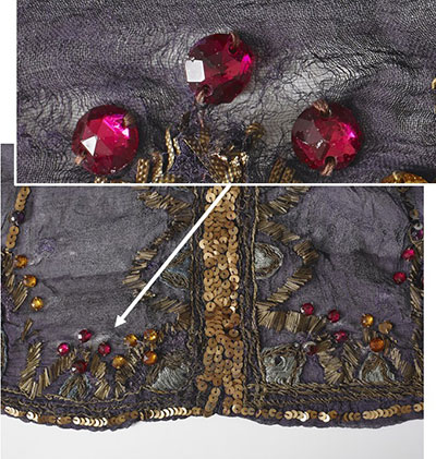 A dance costume shows silk fibres that have torn from the weight of attached decorative elements.