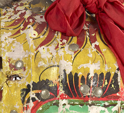 Detail of a Chinese lion dance costume. The paint is flaking and has fallen off in some areas.