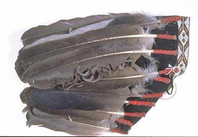 The eagle feather headdress without any mount, laying on its side.